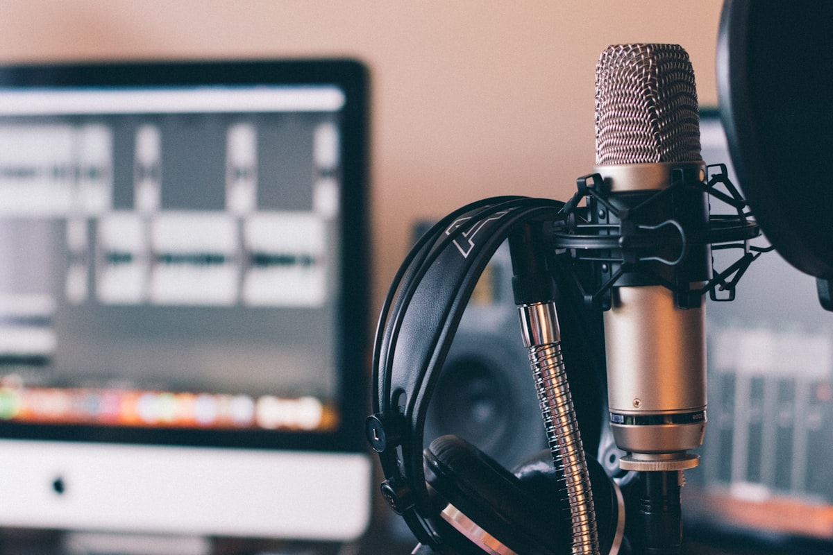 Studio microphone, headphones, and audio editor — the recording setup behind Coach Michelle's appearances on co-parenting and high-conflict podcasts